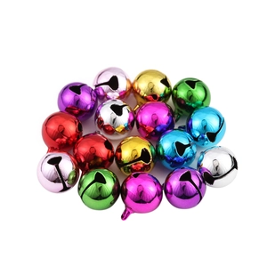 Macro shot of colorful polished metal Christmas bells for DIY crafts and pet accessories