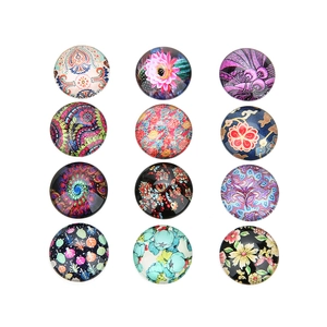 Macro detail of round glass cabochons with colorful tree of life patterns for DIY jewelry