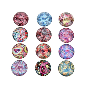 Macro detail of 12 round glass cabochons with colorful Bohemian paisley patterns