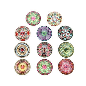 Macro shot of 11 round glass cabochons with colorful mandala kaleidoscope patterns