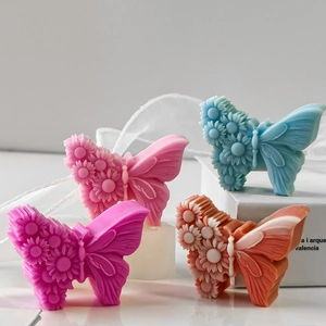Detailed relief patterns on butterfly-shaped handmade candles and soaps in four colors