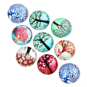 Macro shot of 9 round glass cabochons with colorful tree of life patterns for DIY jewelry