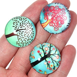 Macro shot of glass Tree of Life cabochons for DIY jewelry making and tray setting