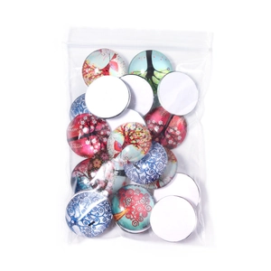 Detailed view of Tree of Life glass cabochons in various artistic patterns and colors