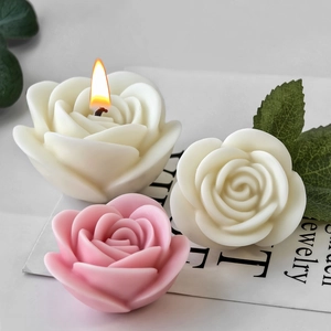 Handmade rose flower scented candles in pink and white wax with realistic petal texture