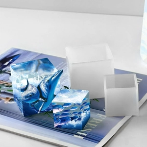 Detail view of cube silicone molds and finished blue ocean resin crafts with dolphins
