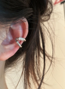Detail shot of a silver double-layer ear cuff featuring pavé cubic zirconia stones