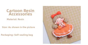 Detailed view of cartoon girl resin flatback in orange dress for DIY crafts and decor