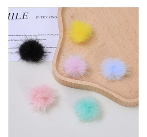 Close-up of soft colorful plush faux fur pom-poms for creative DIY craft accessories