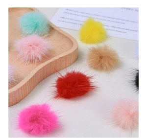 Close-up of colorful faux mink fur pom-poms for DIY crafts and jewelry making accessories