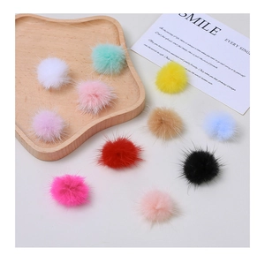 Detail view of colorful faux mink fur pompoms for DIY crafts and accessories making