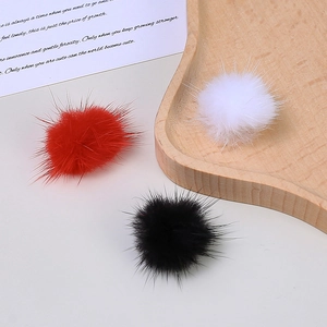 Colorful mink fur pom-poms for DIY crafts and accessories in red, black, and white colors