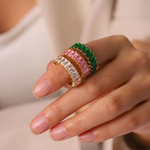 Macro shot of three stacked 18k gold-plated eternity rings with colorful rectangle zircons
