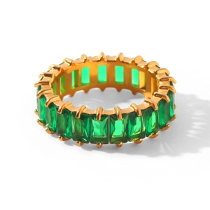 Macro shot of 18k gold plated ring with emerald cut green cubic zirconia stones