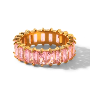 Close-up of gold eternity ring with channel-set pink baguette-cut cubic zirconia gems