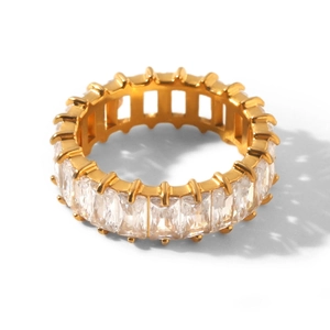 Macro shot of gold eternity ring featuring rectangular cubic zirconia in a claw setting