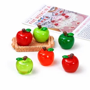 Detailed view of glossy miniature resin apples for creative DIY jewelry crafts