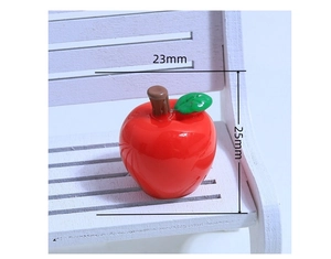 Macro detail of red resin apple charm with 23mm width and 25mm height dimensions