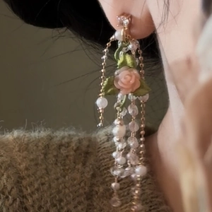 Detailed close-up of French vintage rose earrings featuring long pearl and bead tassels.