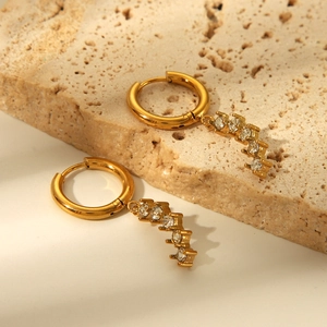 Macro view of clear cubic zirconia stones set in gold stainless steel earring charms