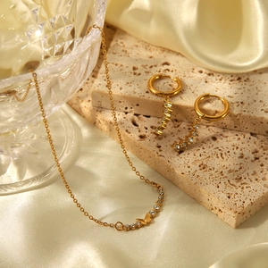 Elegant stainless steel butterfly pendant necklace and linear crystal dangle hoop earrings set.
