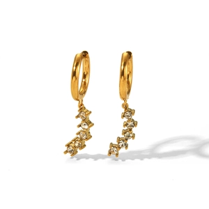 Elegant detail of golden hoop earrings featuring a curved zircon drop pendant design