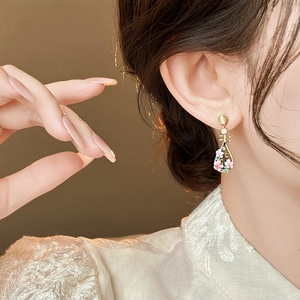 Close-up of elegant pink peach blossom Pipa shaped earrings in traditional Chinese style