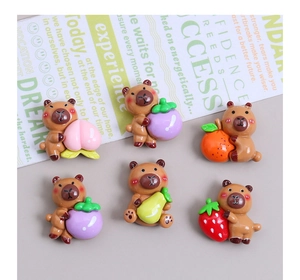 Detailed macro view of 6 assorted resin animal charms holding colorful fruit accessories