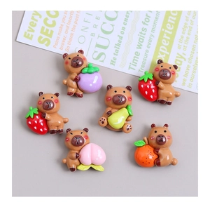 Close-up of six resin capybara figurines holding various fruits for DIY hair clip crafts