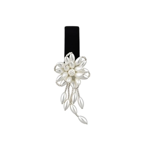 Elegant French-style flower hair clip with pearls and black ribbon on a white background