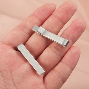 Close-up view showing the brushed metal texture and mechanism of stainless steel tie clips