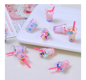 Macro shot of miniature bubble tea resin charms on white plate for DIY crafts decoration