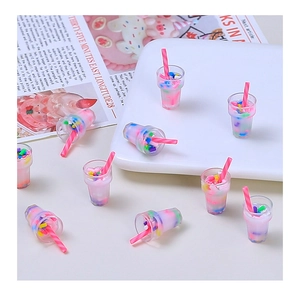 Detailed view of miniature resin milkshake cups with pink cream and colorful sprinkles