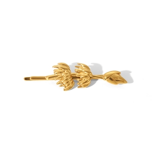 Macro view of high-quality gold-plated stainless steel hair clip with banana design detail