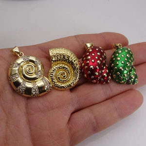 Detail of seashell pendants in gold with zircon, relief, and colorful enamel styles