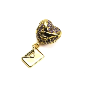 Macro shot of purple cubic zirconia heart charm with a gold-plated envelope pendant