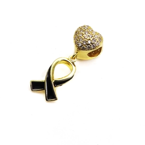 Close-up of heart charm with zircons and black enamel ribbon for snake chain bracelets