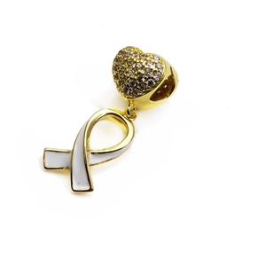 Macro shot of micro-pave zircon heart pendant and white enamel ribbon charm
