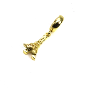 Detailed view of a gold-plated Eiffel Tower charm with inlaid zircons for bracelets