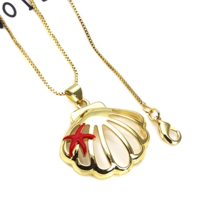 Detail of gold seashell pendant with red starfish charm and durable box chain link