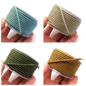 Detailed view of 3.5mm braided dragon pattern cords in four metallic colors on spools