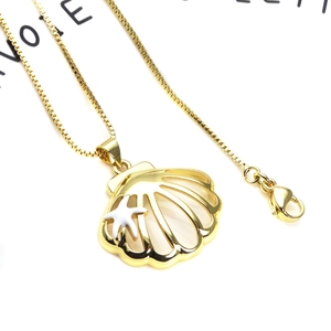 Detailed close-up of shell pendant necklace with zircon and starfish on a box chain