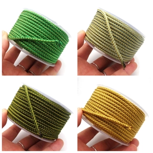 Close-up of 3.5mm metallic dragon pattern braided cords on spools for DIY projects