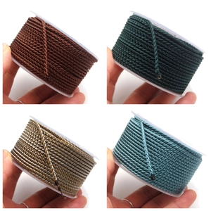 Detailed view of 2.8mm colorful braided dragon cords on spools for DIY jewelry making