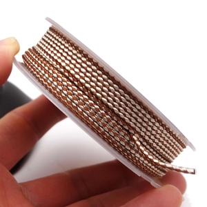 Detailed view of 1.5mm brown and white dragon pattern braided cord on a plastic spool