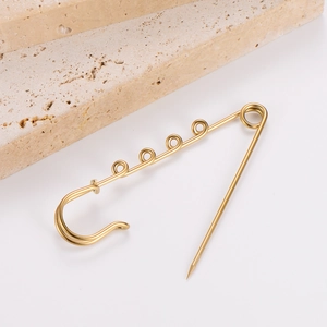 Detailed macro view of 18k gold-plated safety pin brooch for DIY fashion accessories