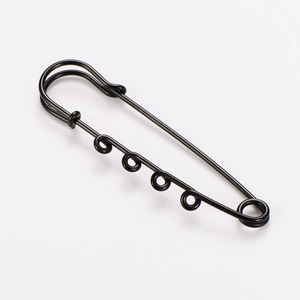 Detail macro view of a minimalist black metal multi-loop safety pin for DIY crafts