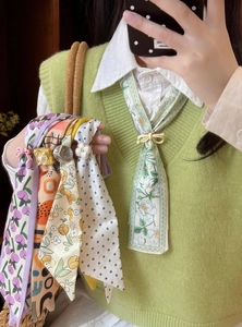 Detailed view of various floral and polka dot patterned silk skinny scarves for neck decoration