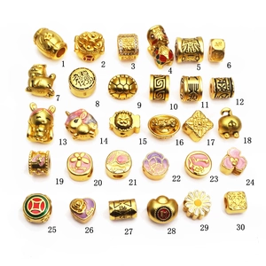 Selection of gold-plated charms and spacer beads for DIY jewelry with traditional Chinese motifs