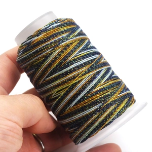 Detailed macro view of multi-colored waxed thread spool for DIY jewelry weaving crafts